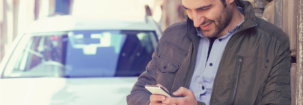 car with man holding phone